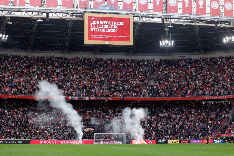 Ajax vs Feyenoord ABANDONED after 55 minutes after flares are thrown on pitch in wild scenes