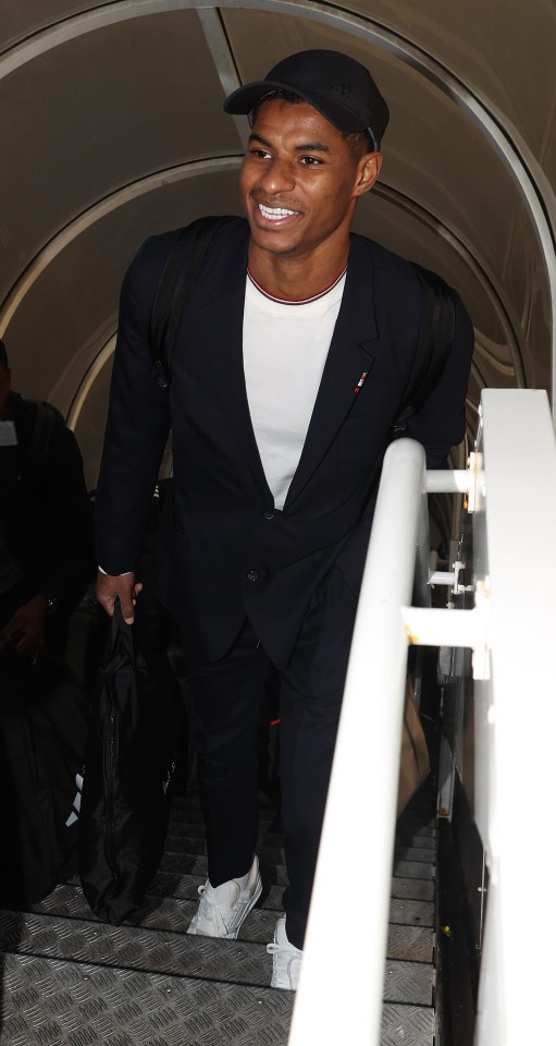 Marcus Rashford smiles as he travels with Man Utd to Copenhagen in injury boost as little-known youngster joins squad
