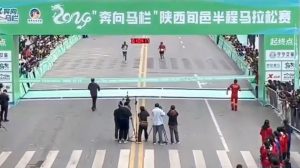 Watch hilarious moment fake marathon runner tries to cheat victory before being tackled by quick-thinking race official