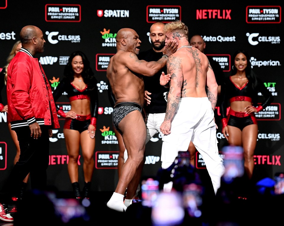 Mike Tyson SLAPS Jake Paul before being pulled apart by security in chaotic weigh in before controversial Netflix fight