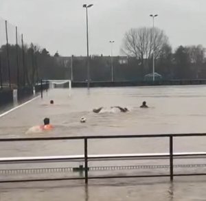 Non-league stars go SWIMMING on their pitch as entire stadium covered in water as Storm Bert wreaks havoc