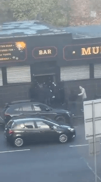 Shock moment Scottish football ultras clash on busy Glasgow street as fans chased by rival hooligans into pub doorway